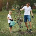 father-with-little-son-are-planting-tree-yard